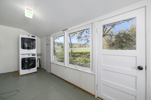 laundry area featuring stacked washer and clothes dryer and laundry area