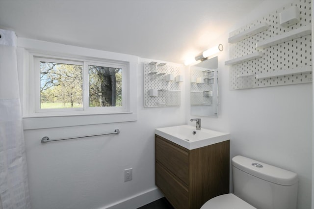 full bathroom with toilet and vanity