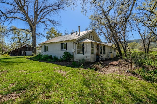 view of side of home with a yard