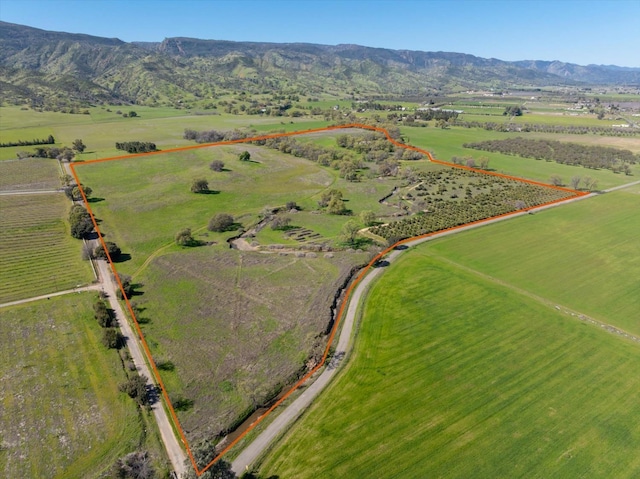 birds eye view of property featuring a mountain view and a rural view