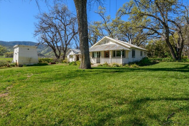 view of front of property featuring covered porch and a mountain view