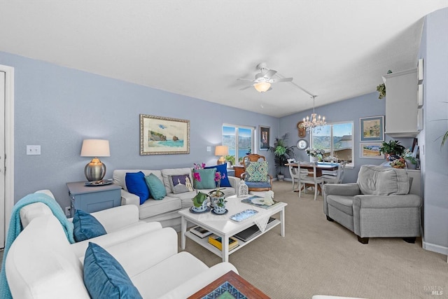 living area with light carpet and ceiling fan with notable chandelier