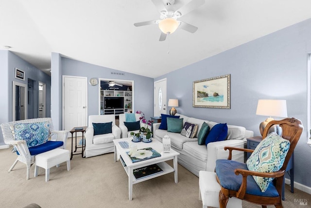 living room featuring baseboards, visible vents, ceiling fan, vaulted ceiling, and light carpet