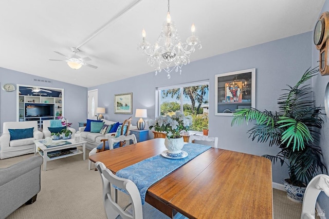 dining room with lofted ceiling, ceiling fan with notable chandelier, and carpet floors