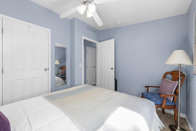 carpeted bedroom with visible vents and a ceiling fan