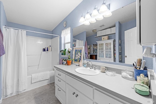 bathroom with visible vents, shower / bath combo, and vanity