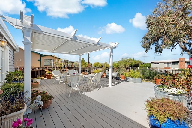 wooden terrace featuring outdoor dining area and a pergola