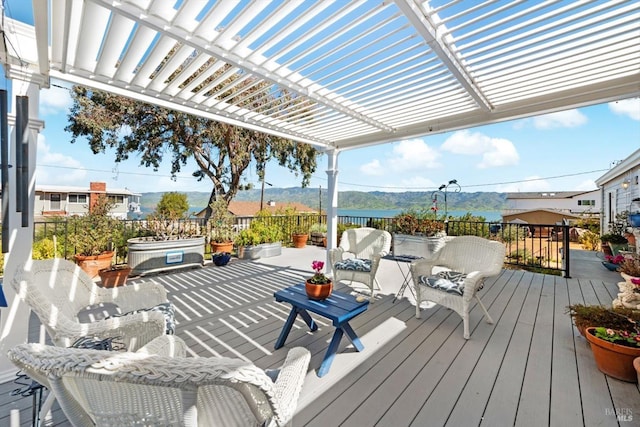 wooden deck with a mountain view and a pergola