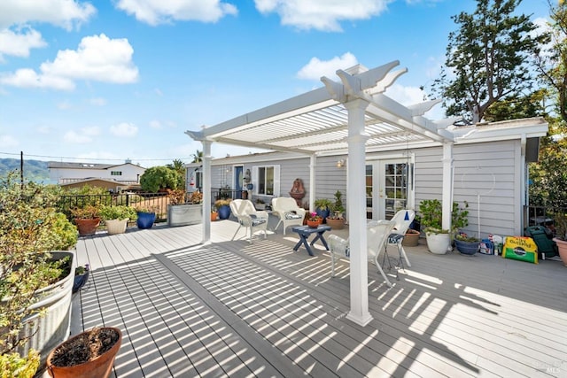 deck with french doors and a pergola