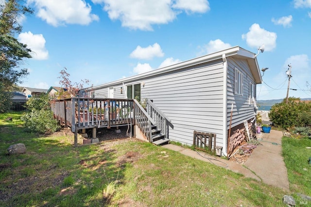 exterior space featuring a lawn and a wooden deck