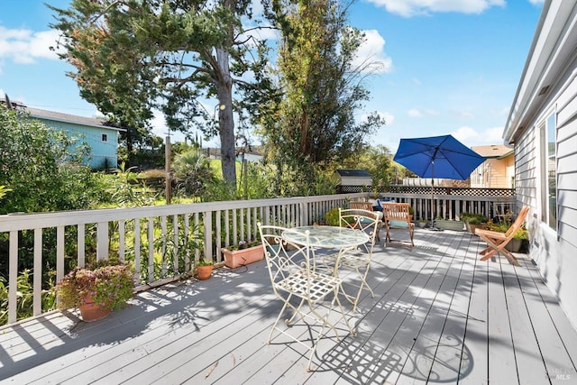 wooden terrace featuring outdoor dining area