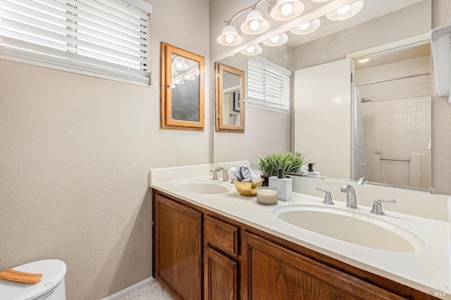 bathroom with a wealth of natural light, toilet, and a sink