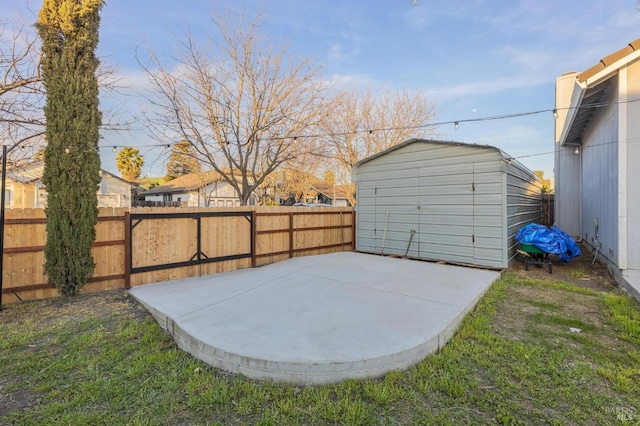exterior space featuring a storage shed, an outbuilding, and a fenced backyard