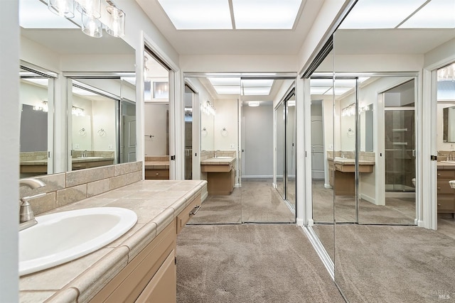 full bath featuring baseboards and vanity