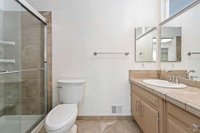 full bath with vanity, toilet, visible vents, and a stall shower