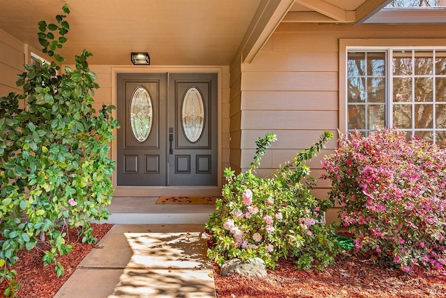 view of exterior entry featuring covered porch