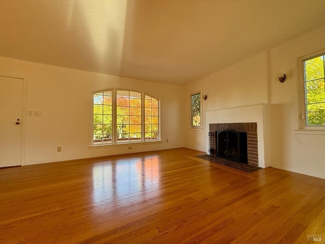 unfurnished living room featuring a fireplace and wood finished floors