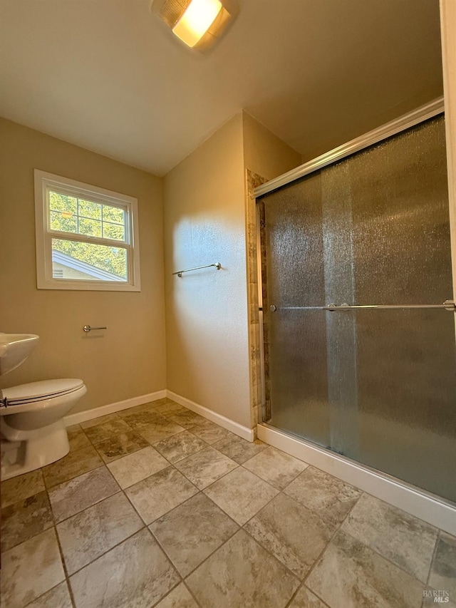 full bath with a shower stall, toilet, and baseboards