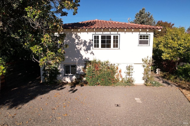 view of front of home with a tile roof