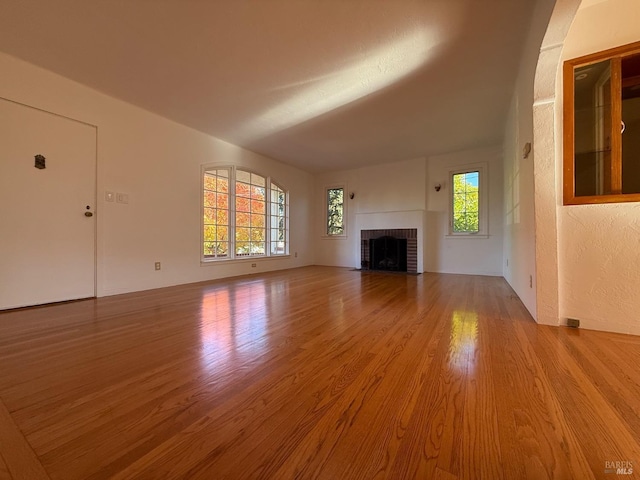 unfurnished living room featuring a fireplace and wood finished floors