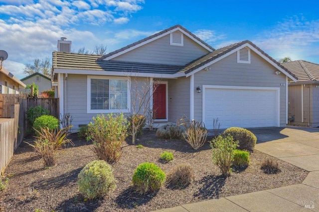 view of front of property with fence, driveway, an attached garage, a chimney, and a tiled roof