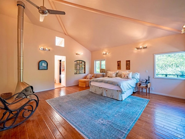 bedroom featuring hardwood / wood-style flooring, beamed ceiling, baseboards, and high vaulted ceiling