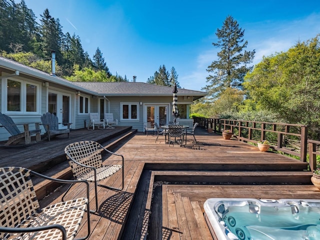 deck featuring french doors and hot tub deck surround