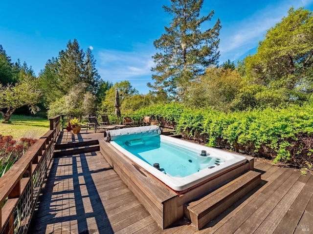 wooden deck with hot tub deck surround