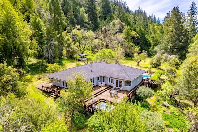 birds eye view of property with a forest view