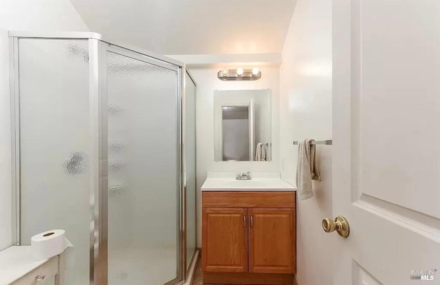 bathroom featuring a stall shower and vanity