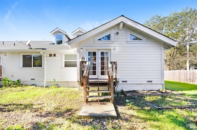 back of property with a lawn, french doors, fence, and crawl space