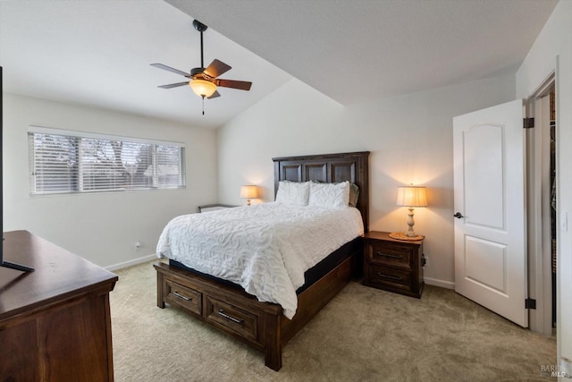 bedroom featuring lofted ceiling, a ceiling fan, baseboards, and light carpet