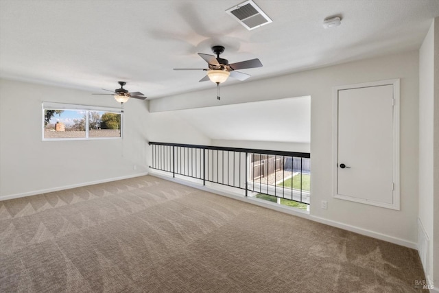 carpeted empty room with baseboards and visible vents