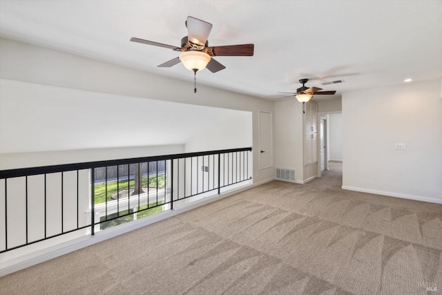 carpeted empty room with visible vents and baseboards