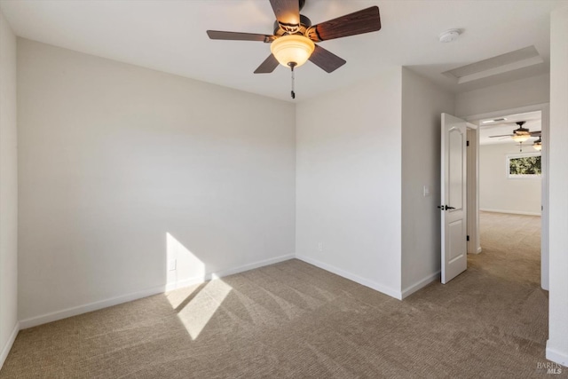 carpeted spare room with baseboards