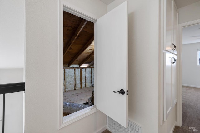 interior space featuring carpet floors and vaulted ceiling