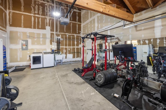 garage featuring electric panel, a sink, white refrigerator with ice dispenser, a garage door opener, and washing machine and clothes dryer