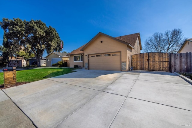 single story home with a gate, fence, concrete driveway, an attached garage, and a front yard