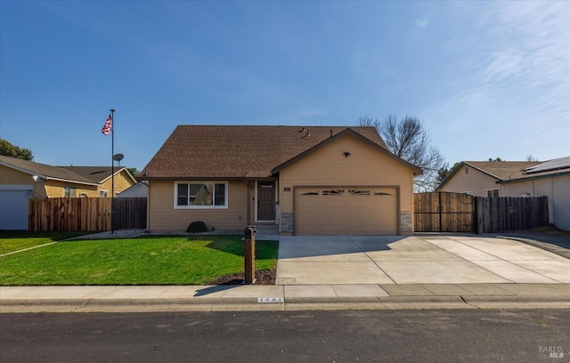 single story home with a front yard, fence, a garage, and driveway