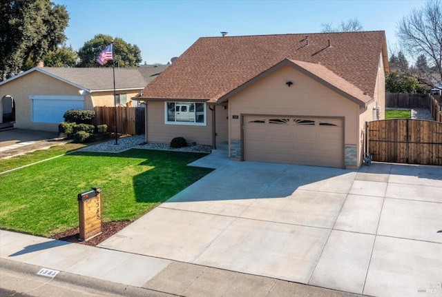 ranch-style home featuring driveway, a gate, fence, a front yard, and a garage