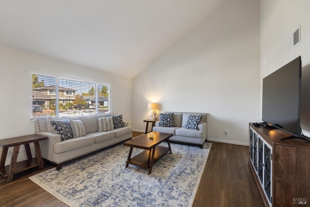 living area with visible vents, wood finished floors, baseboards, and high vaulted ceiling