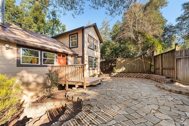 back of house featuring a patio, fence, and a wooden deck