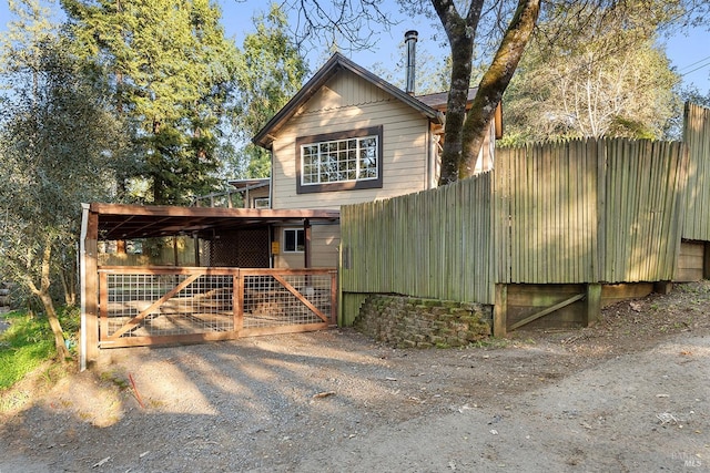 view of front of home with an outdoor structure and fence