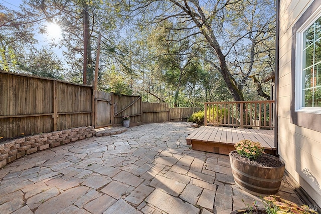 view of patio with a deck and a fenced backyard