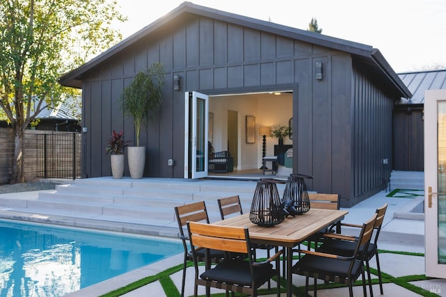 exterior space with an outbuilding, an exterior structure, a fenced in pool, and fence