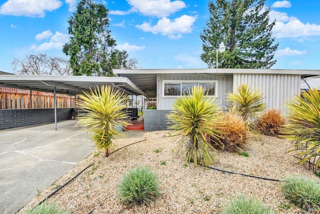 view of front facade with a carport and fence