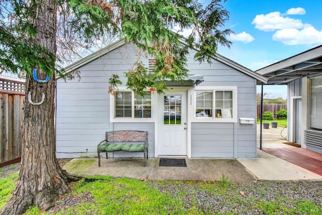 rear view of property with a patio area and fence