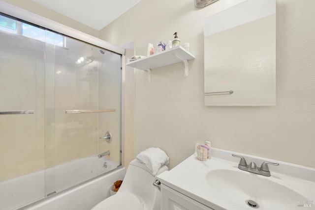 full bathroom with toilet, vanity, and bath / shower combo with glass door