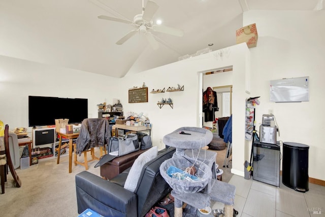 living room featuring lofted ceiling, a ceiling fan, and baseboards