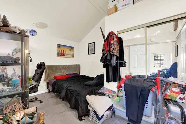 bedroom featuring a closet, carpet flooring, and lofted ceiling